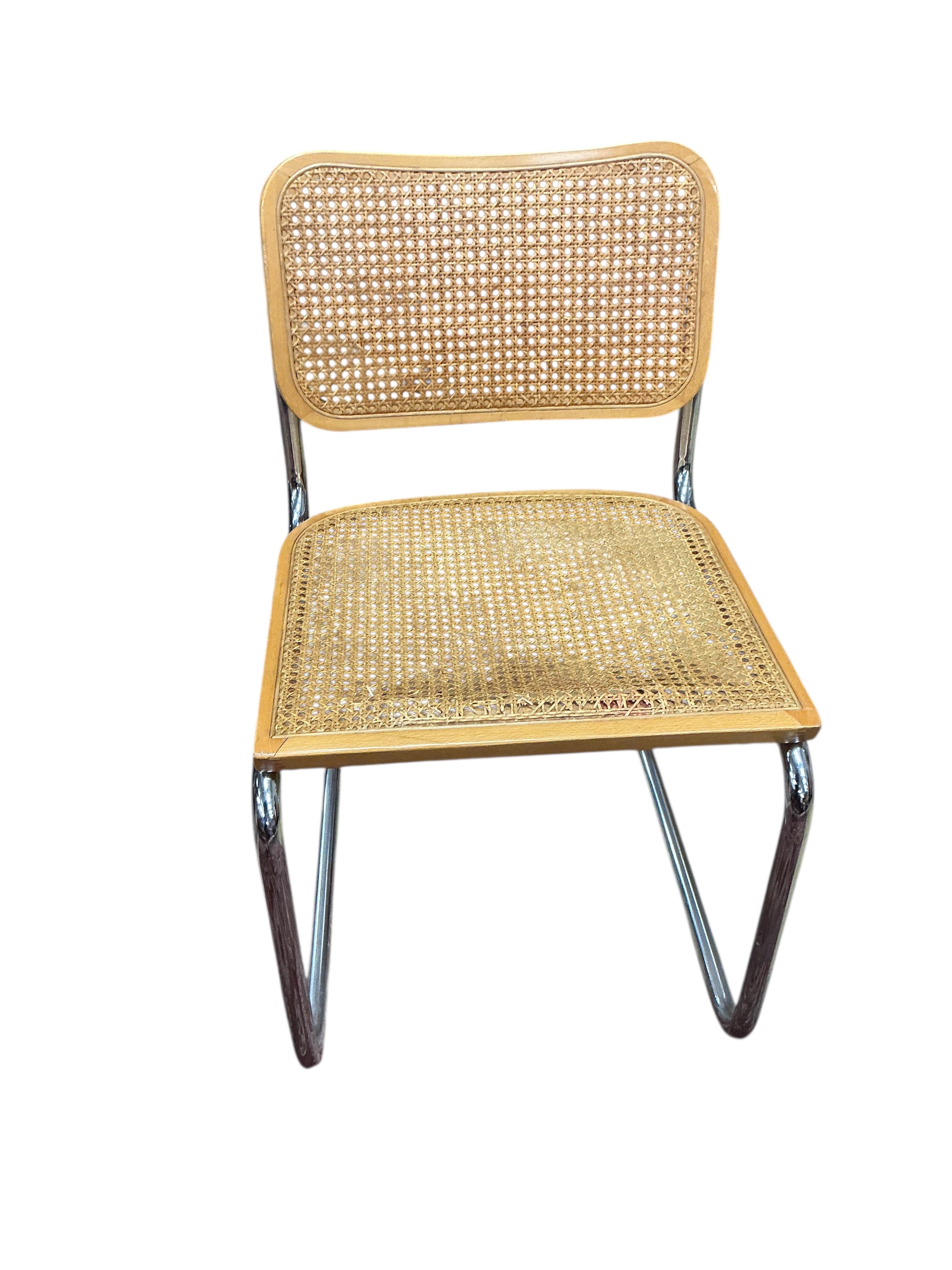 After Marcel Breuer a Cesca style circular table, diameter 112cm, height 72cm and four caned cantilever chairs, possibly Habitat.